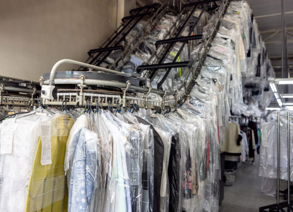 Clothes hanging on the conveyor belt at an industrial laundry
